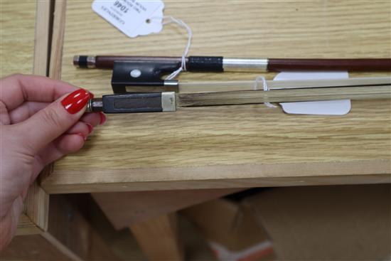 Two round stick violin bows with mother of pearl inlay, one with white metal mount